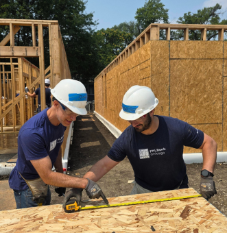 Two FHLBank Chicago Employees working on a Habitat Build