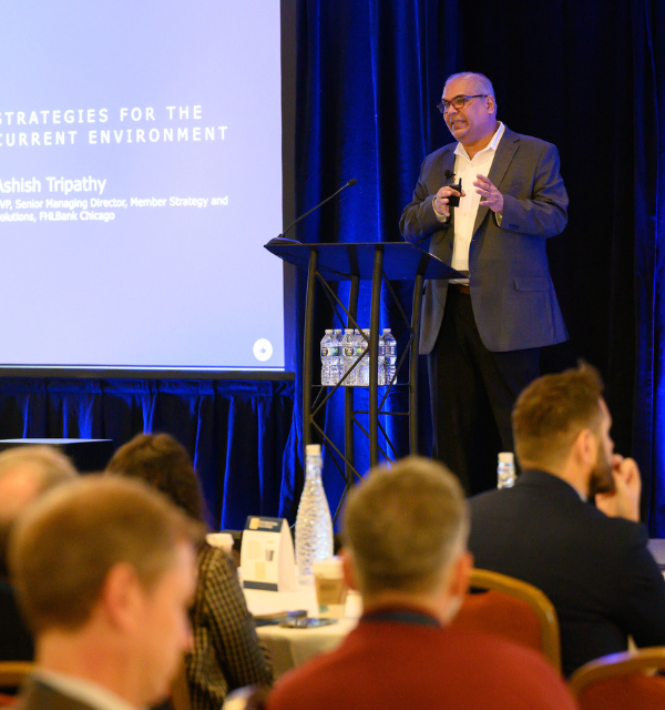 Ashih speaking to the crowd at a member meeting