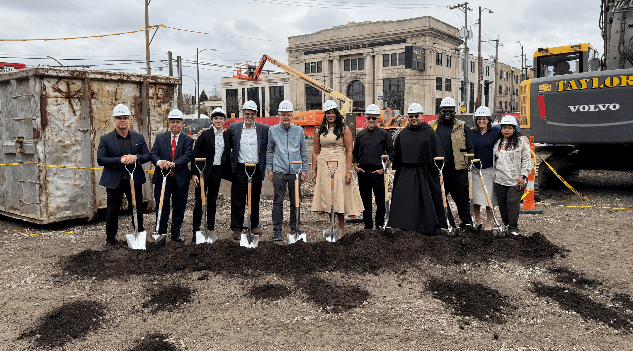Several local dignitaries, developers, and members posing for a groundbreaking photo.