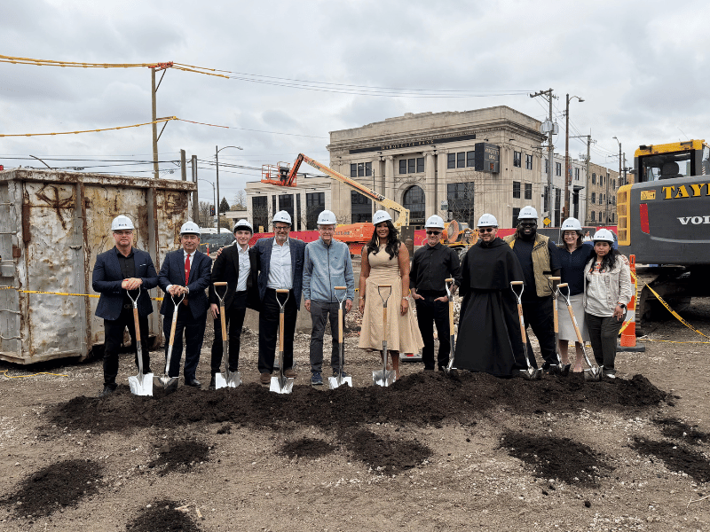 Several local dignitaries, developers, and members posing for a groundbreaking photo.